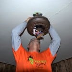 Electrician installing ceiling fan