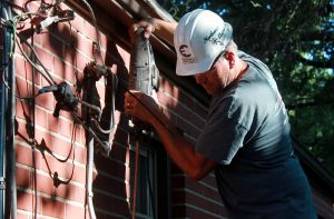 Kevin Stecher begins work on installing a new mast and   weather head