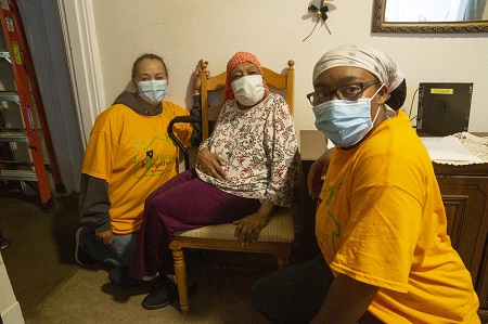 Three women posing with masks