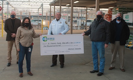 People posing with giant check