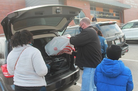 Man loading gifts into back of car