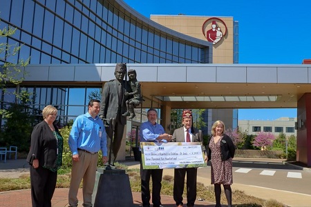 TSI-Global presenting check to to Shriners Hospital