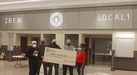 People posing with giant check